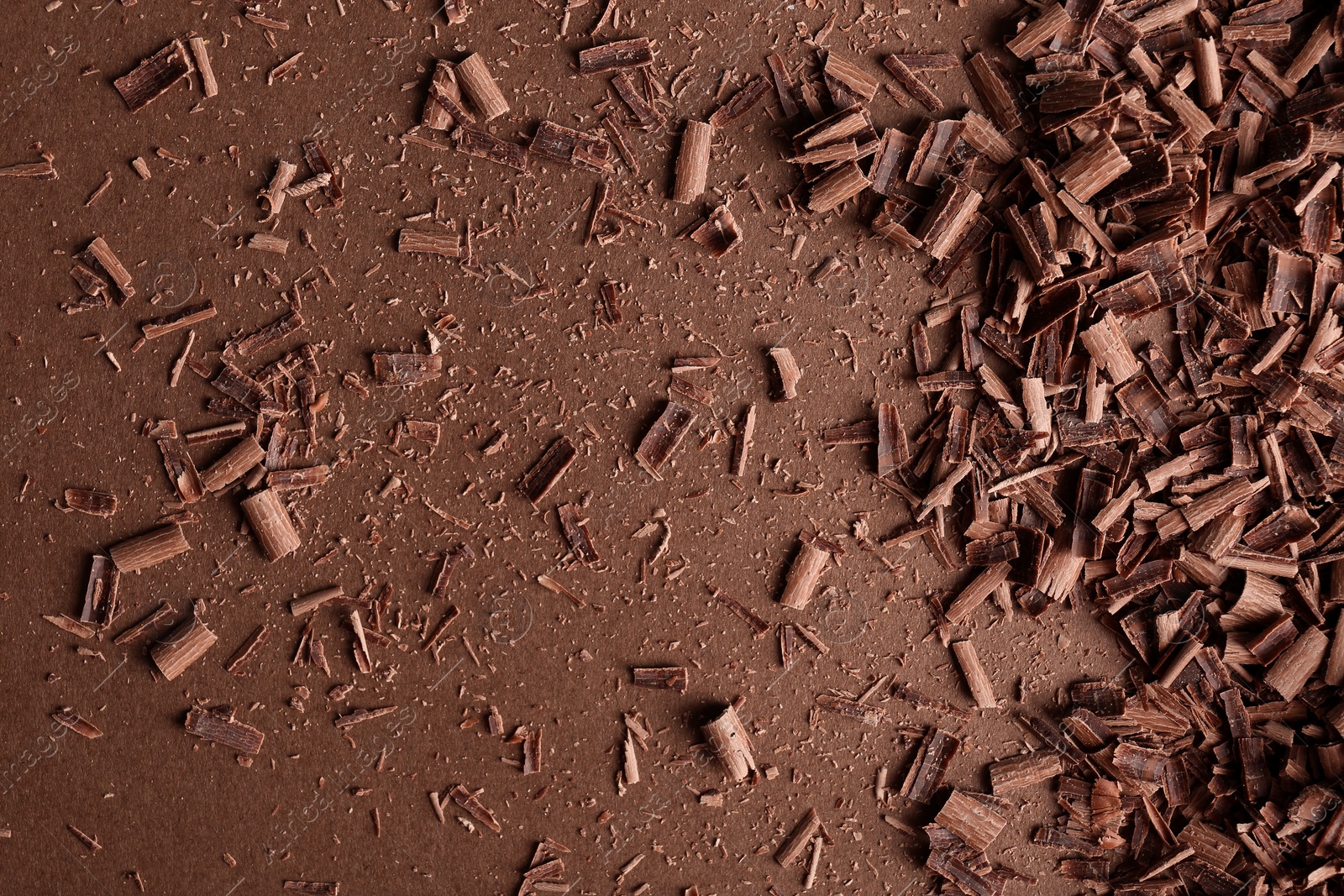 Photo of Chocolate curls and space for text on color background, top view