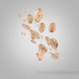 Image of Rolled oat flakes falling on grey background