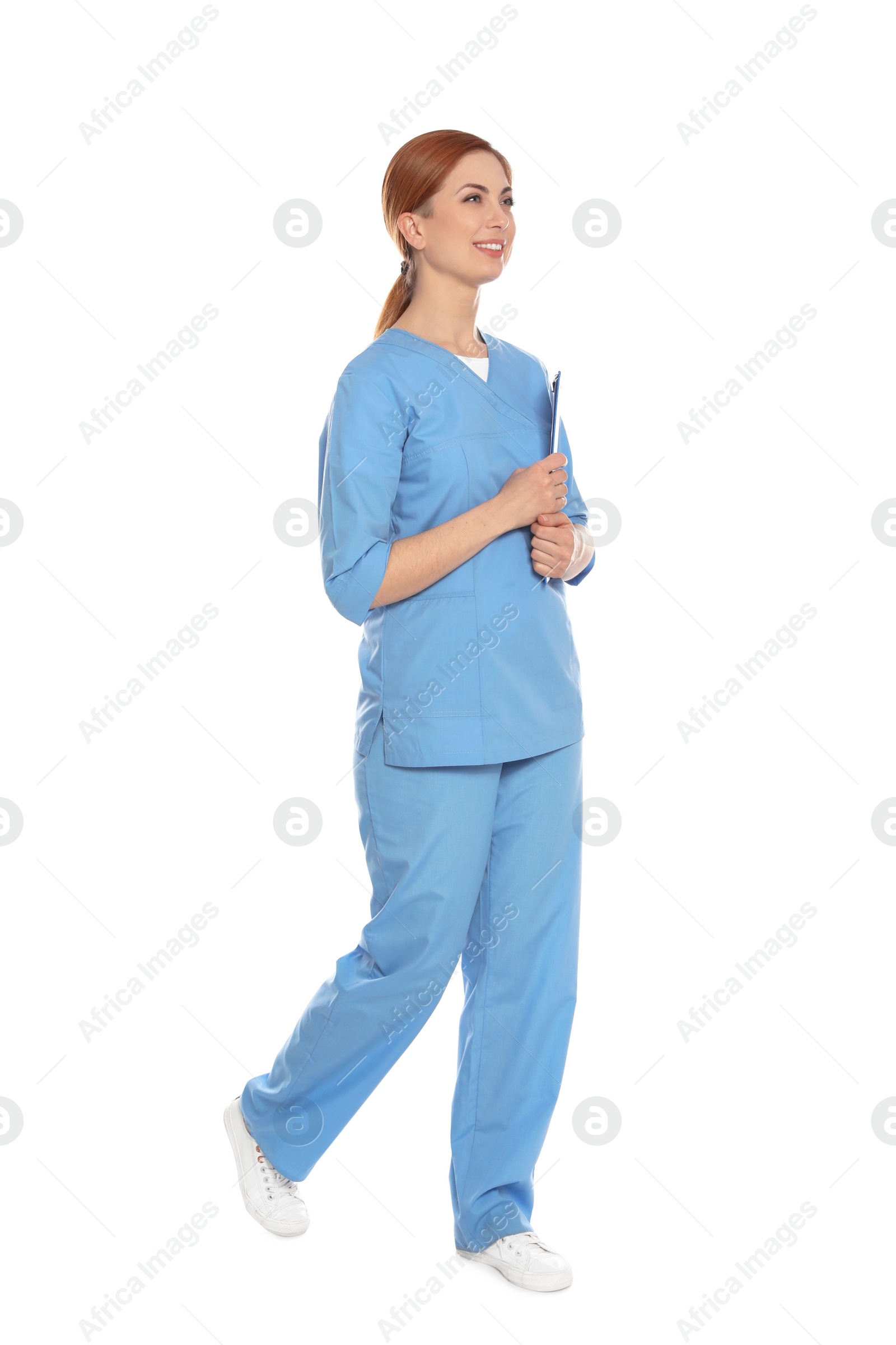 Photo of Full length portrait of medical doctor with clipboard isolated on white