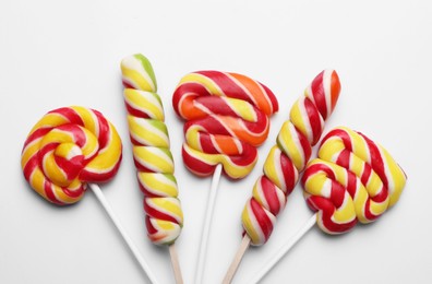 Sweet lollipops on light background, flat lay