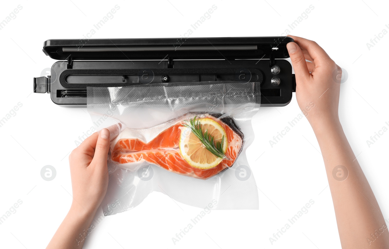 Photo of Woman using vacuum sealer on white background, top view. Salmon with lemon in pack