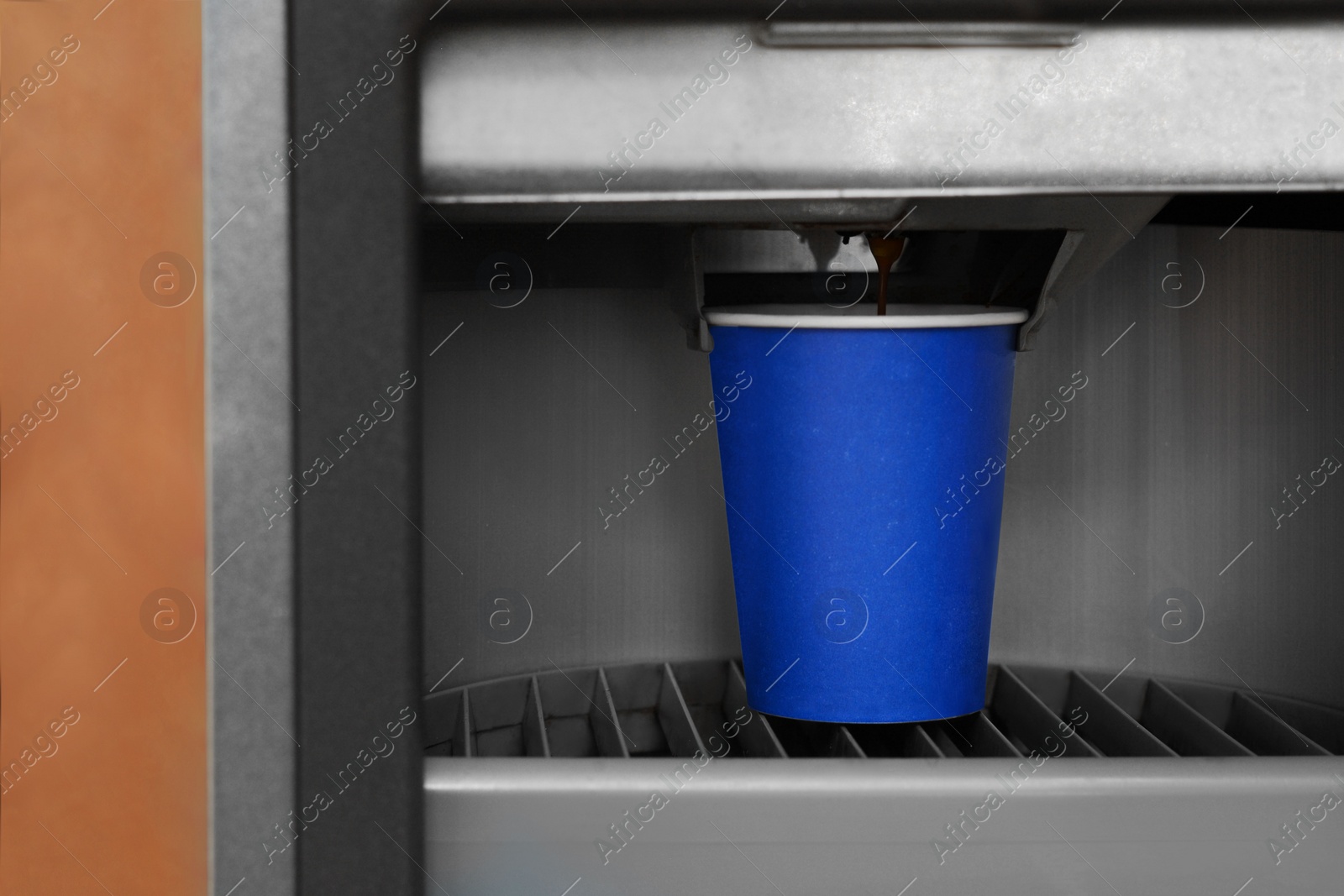 Photo of Vending machine pouring coffee in paper cup, closeup