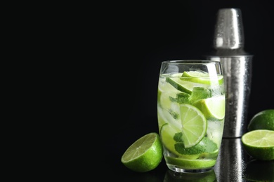 Delicious mojito and ingredients on black background. Space for text