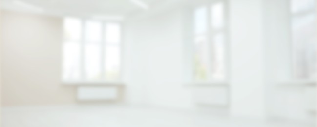 Empty room with white walls and large windows, blurred view. Banner design