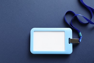 Photo of Blank badge with string on blue background, top view