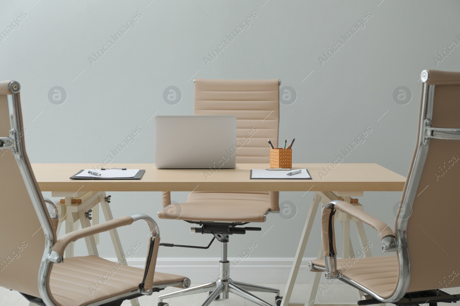 Photo of Director's office with large wooden table and comfortable armchairs. Interior design