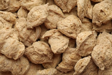Dehydrated soy meat chunks as background, top view