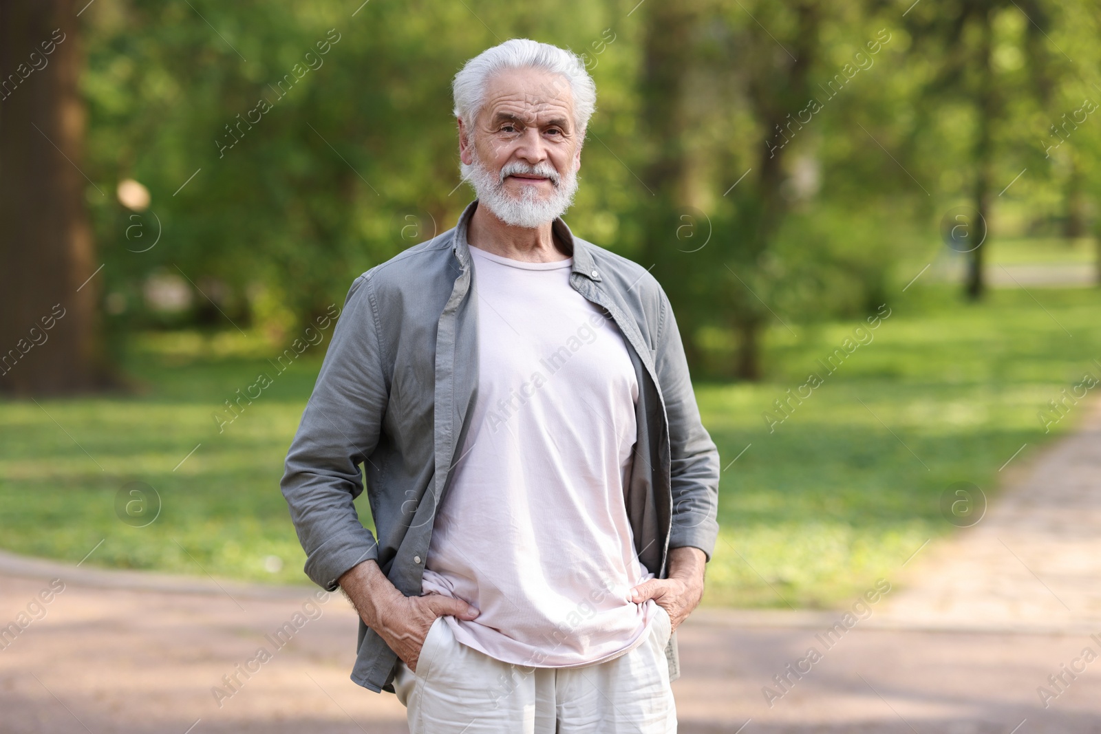 Photo of Portrait of happy grandpa in spring park