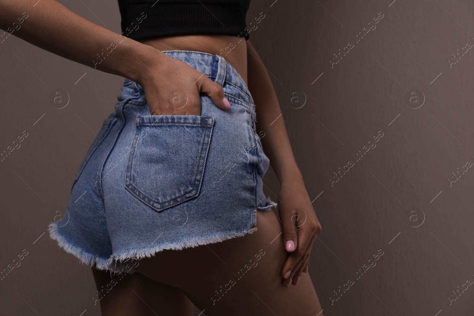 Photo of Closeup view of slim woman on beige background, space for text. Cellulite problem concept