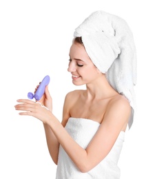 Young woman applying hand cream on white background