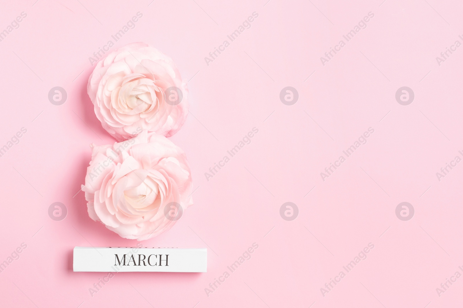 Photo of International Women's day. 8th of March made with beautiful flowers on light pink background, top view. Space for text