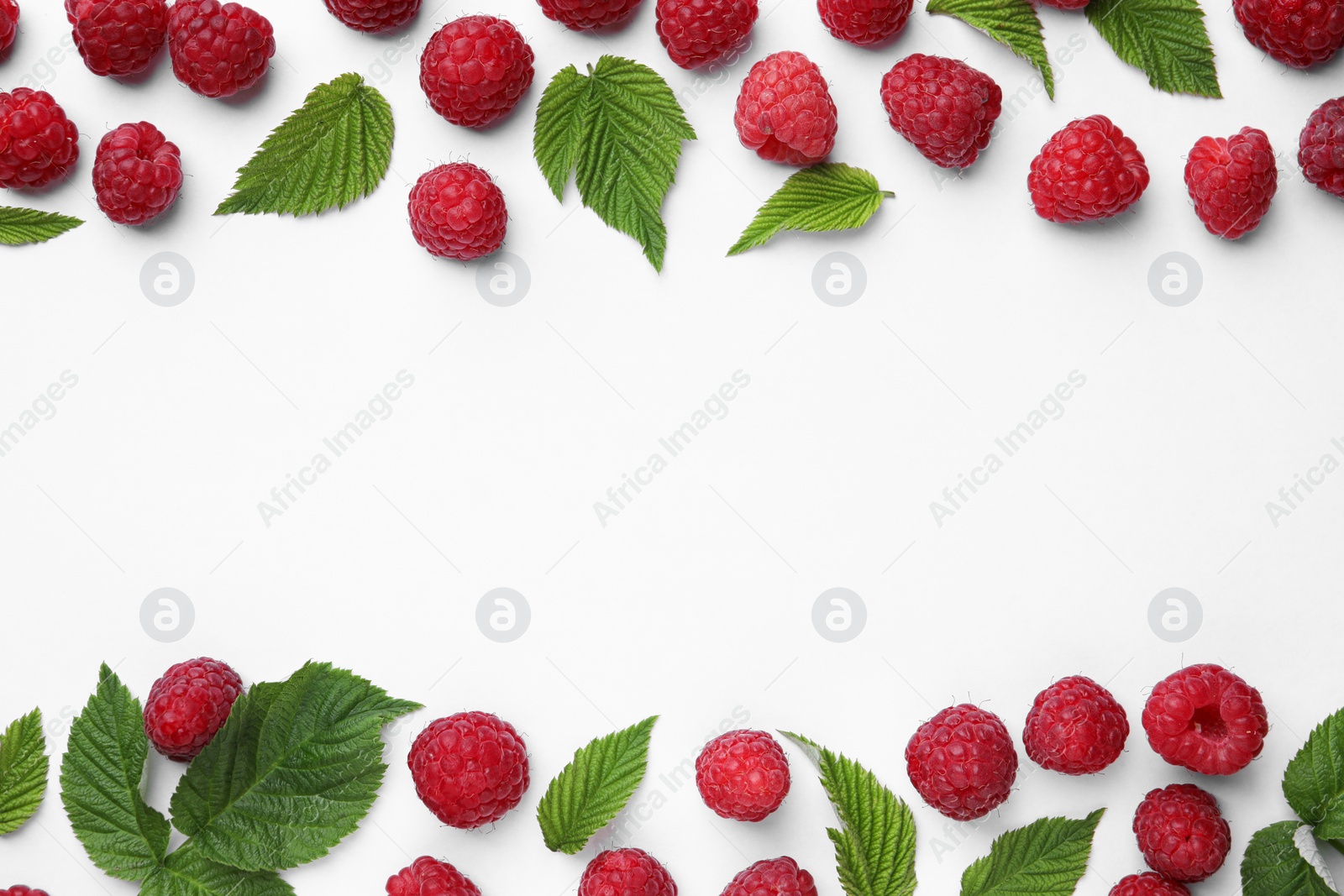 Photo of Tasty ripe raspberries and green leaves on white background, flat lay. Space for text