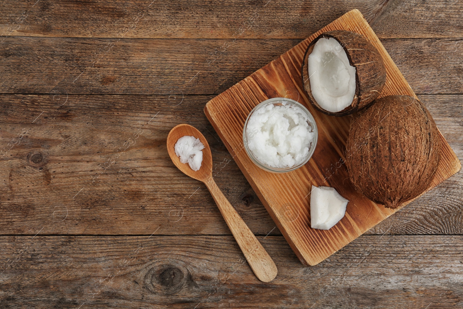 Photo of Flat lay composition with coconut oil on wooden table. Cooking ingredients