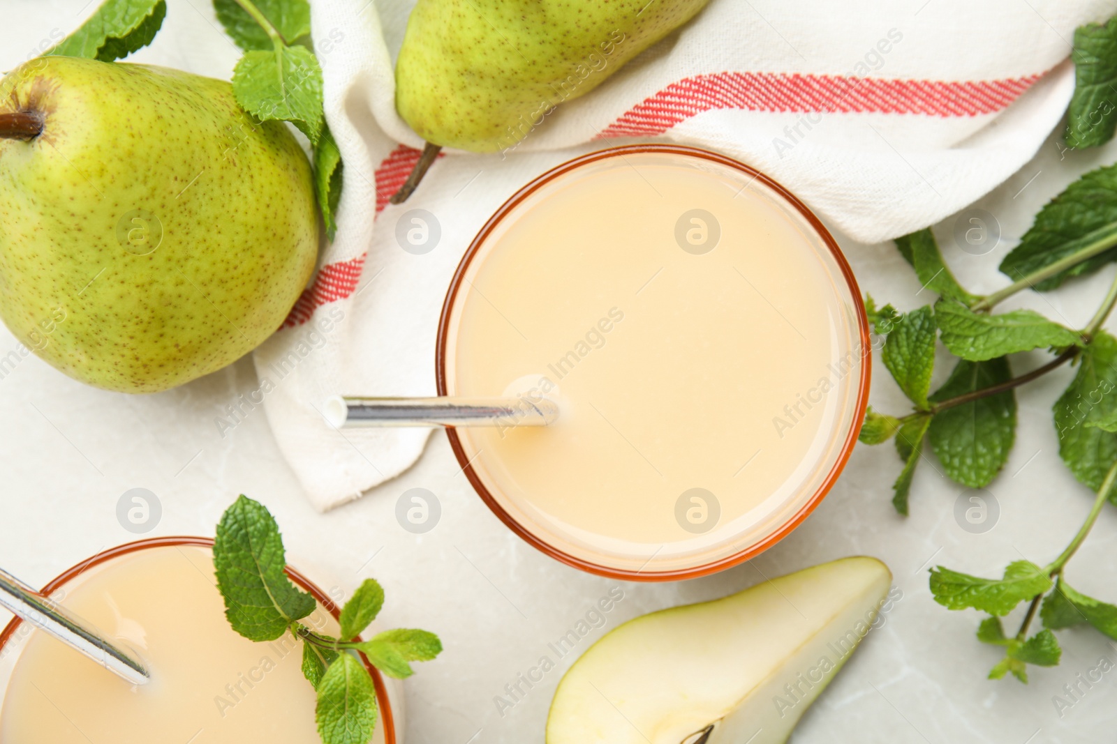 Photo of Tasty pear juice with mint and fruits on light grey marble table, flat lay