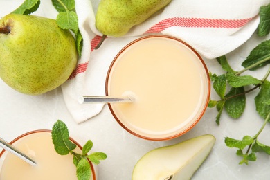 Tasty pear juice with mint and fruits on light grey marble table, flat lay