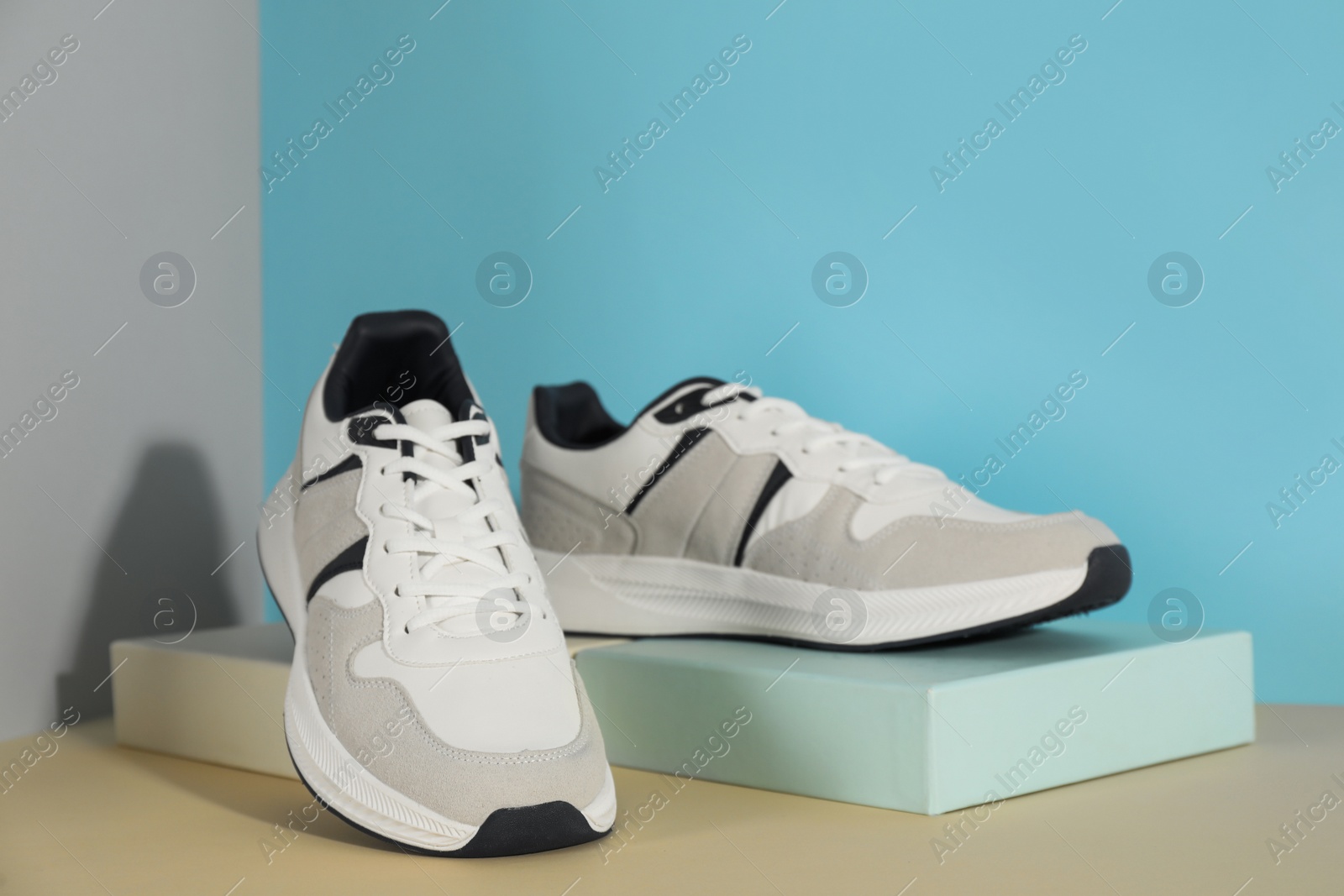 Photo of Pair of stylish sneakers on color background