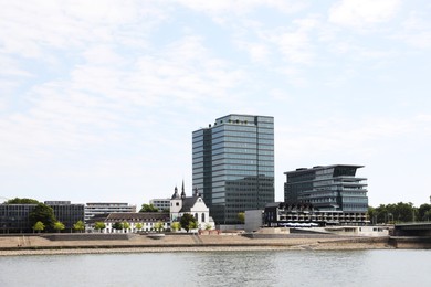 Picturesque view of modern city architecture near river