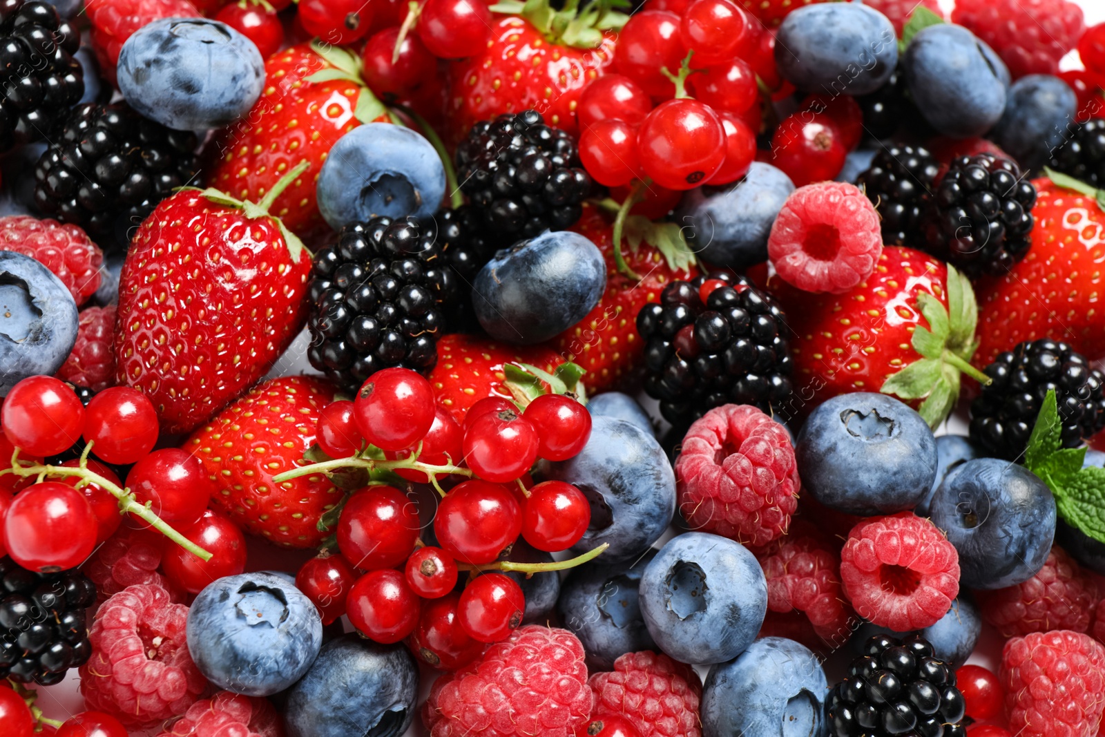 Photo of Mix of fresh delicious berries as background, top view