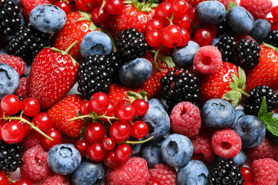 Photo of Mix of fresh delicious berries as background, top view