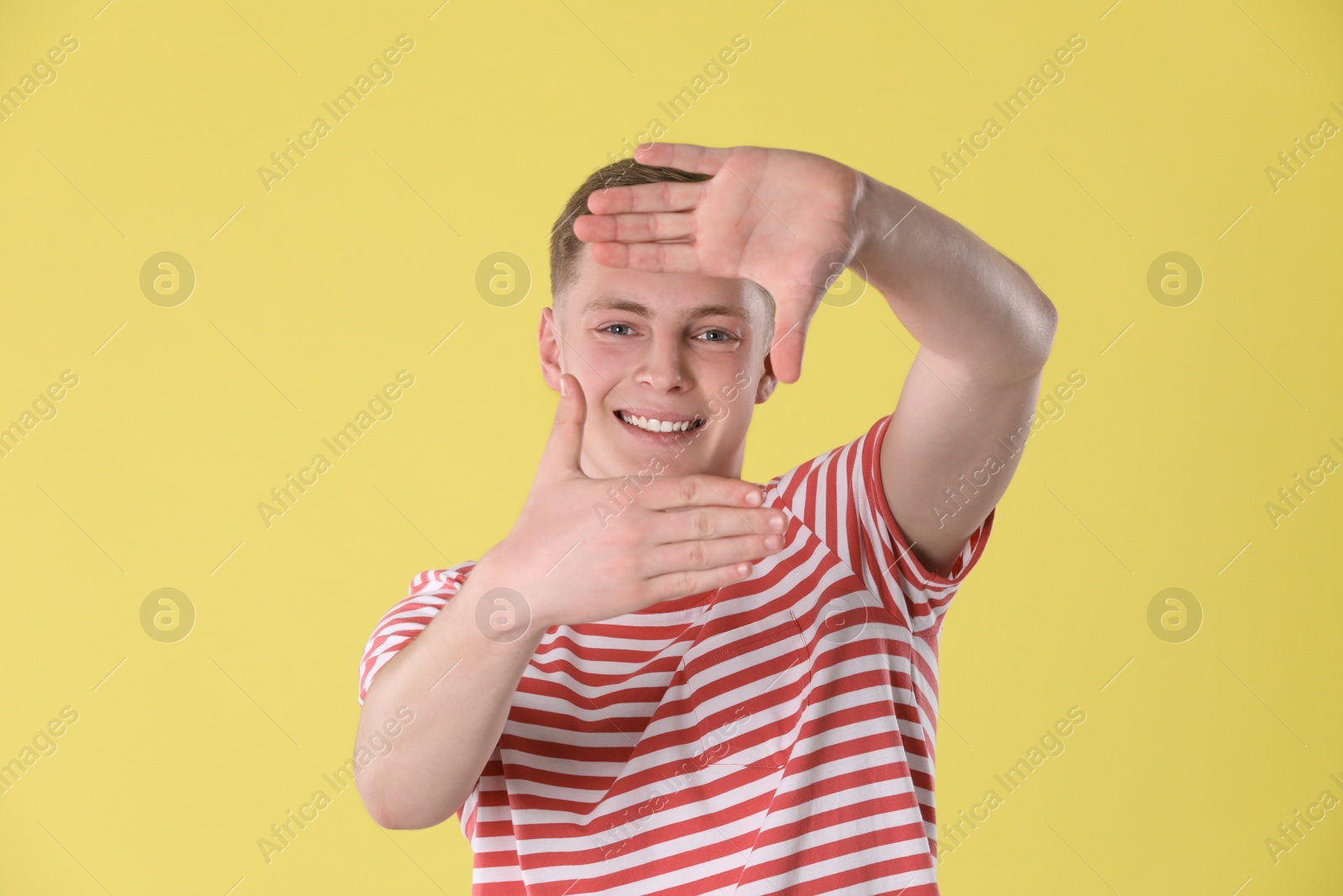 Photo of Portrait of teenage boy on yellow background