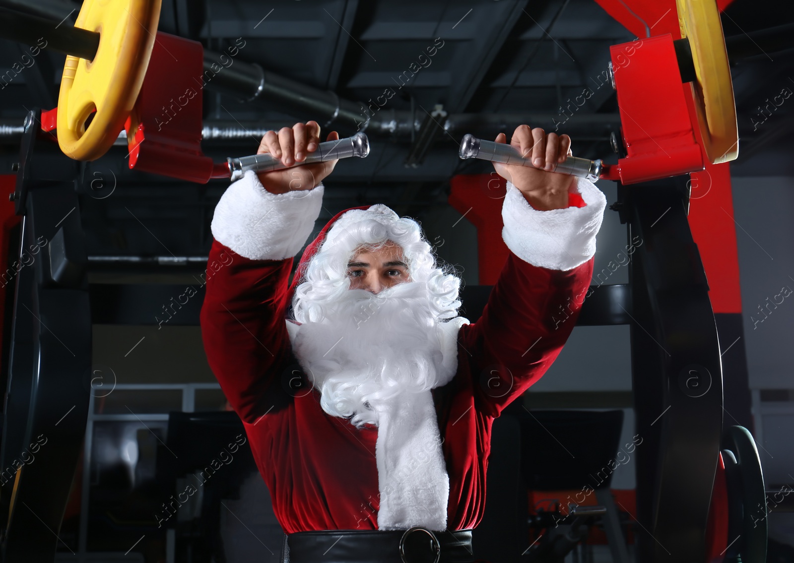 Photo of Young Santa Claus training in modern gym