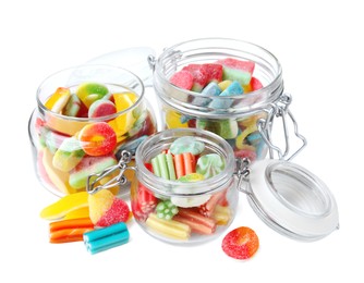 Tasty jelly candies in jars on white background