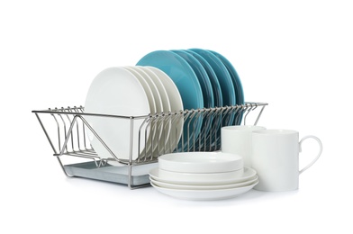 Photo of Rack with dishes and clean tableware on white background