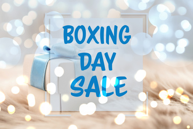Image of Text Boxing Day Sale and gift with blurred Christmas lights on background