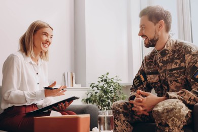 Photo of Psychologist working with military officer in office