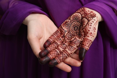 Photo of Woman with henna tattoo on palm, closeup. Traditional mehndi ornament