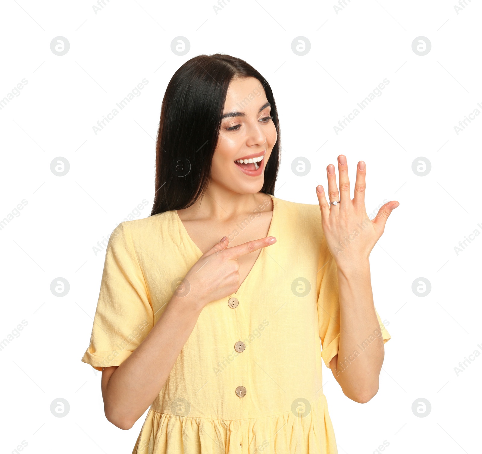 Photo of Happy young woman wearing beautiful engagement ring on white background