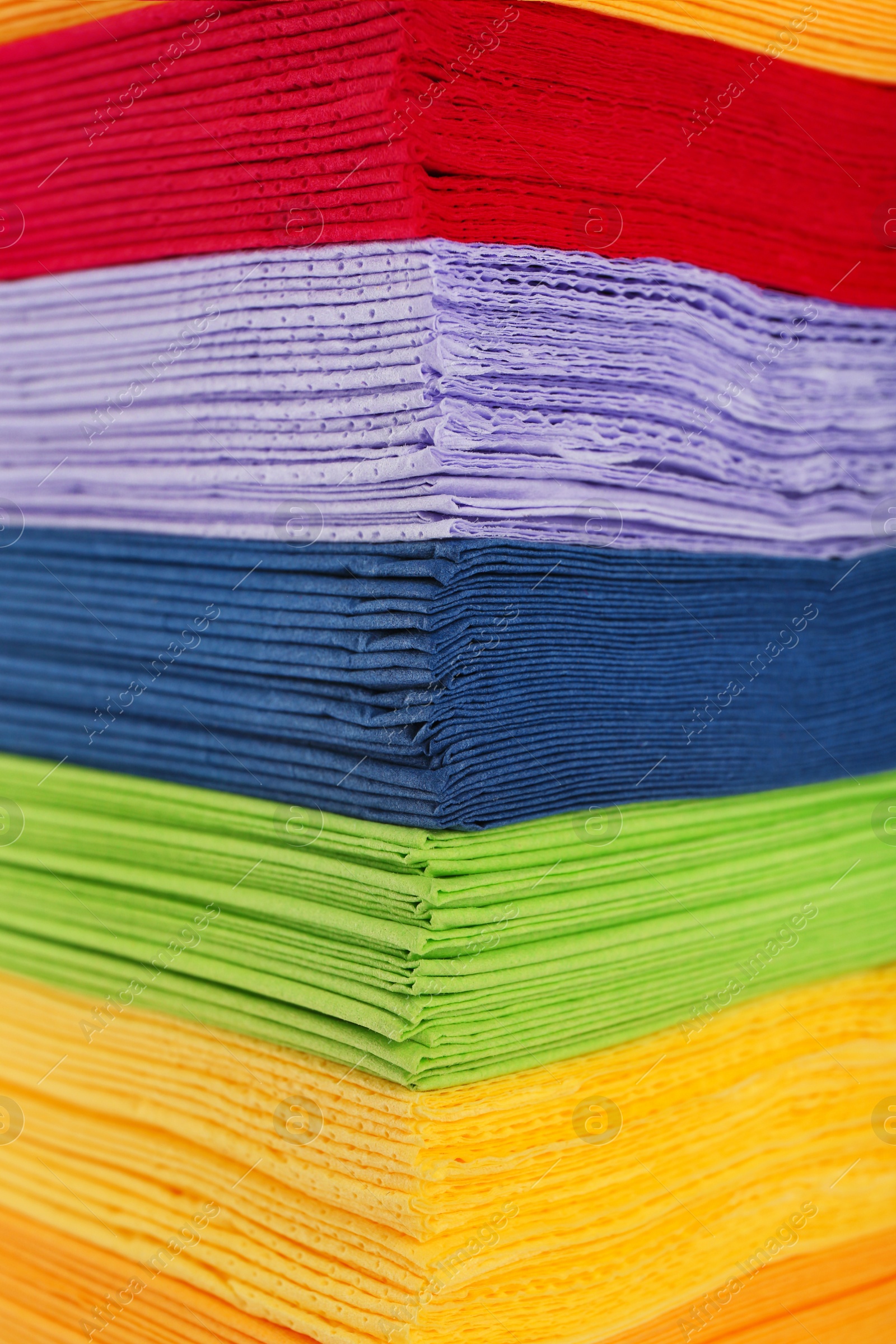 Photo of Stack of colorful paper napkins as background, closeup