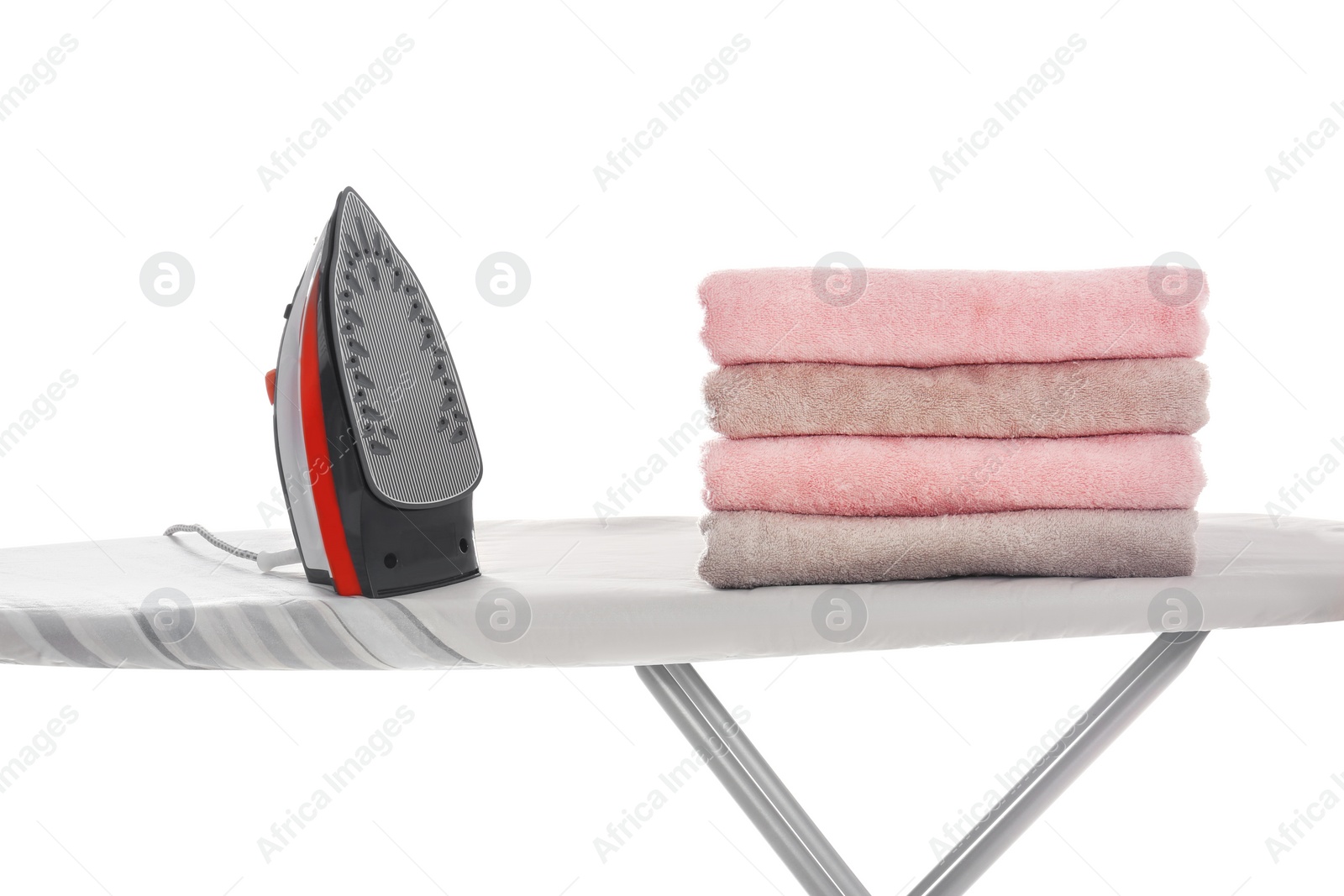 Photo of New modern iron and clean towels on board against white background. Laundry day