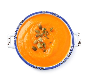 Image of Tasty creamy pumpkin soup in bowl on white background, top view