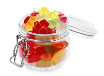 Glass jar with delicious jelly bears on white background