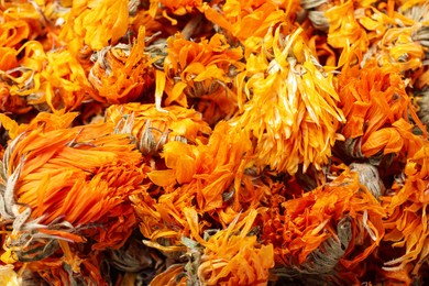 Pile of dry calendula flowers as background, closeup