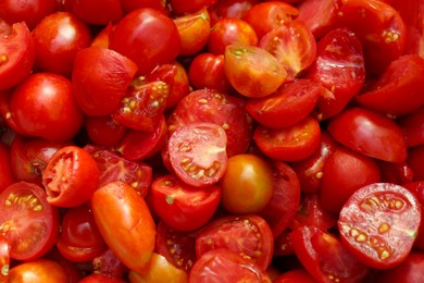 Photo of Cut red ripe tomatoes as background, top view