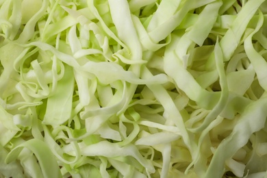 Photo of Chopped white cabbage as background, closeup view