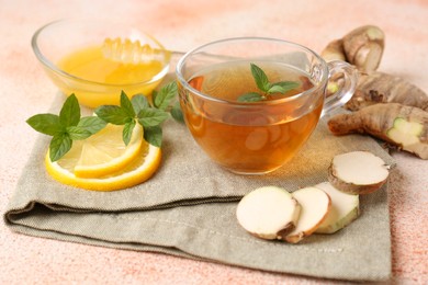 Tea with mint, honey, lemon and ginger on table
