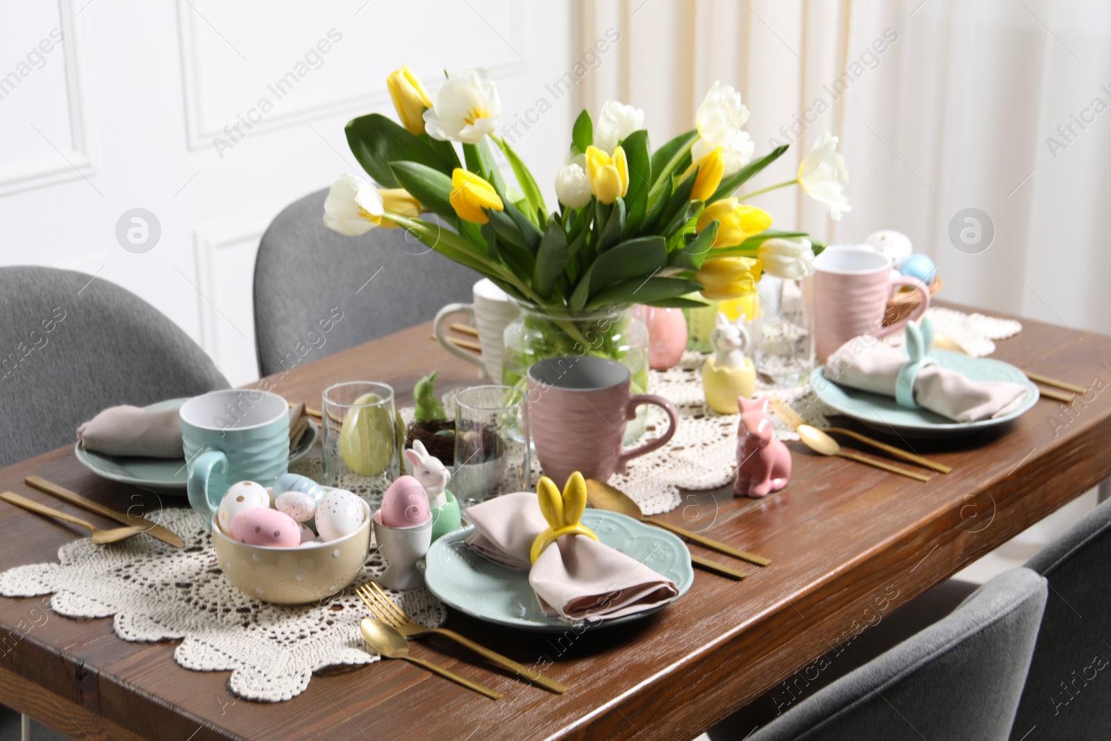 Photo of Festive table setting with beautiful flowers. Easter celebration