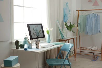 Photo of Stylish workplace interior with modern computer on desk