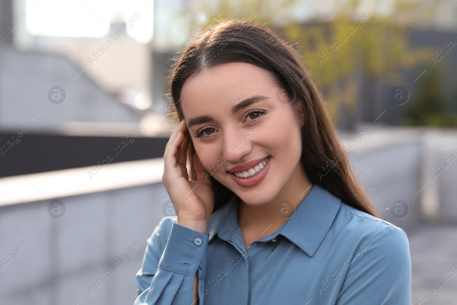 Photo of Portrait of beautiful woman outdoors. Attractive lady smiling and looking into camera