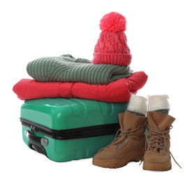 Suitcase with warm clothes isolated on white. Winter vacation