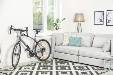 Photo of Modern living room interior with bicycle near wall