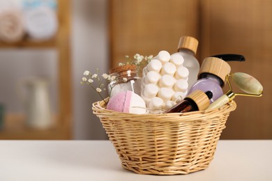 Photo of Spa gift set with different products on white table in bathroom