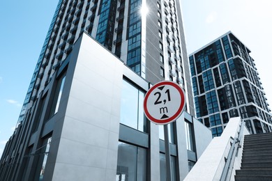 Photo of Traffic sign Height limit near modern building, low angle view