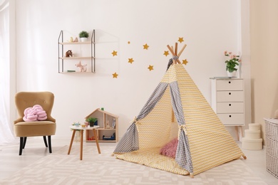 Cozy kids room interior with play tent and toys