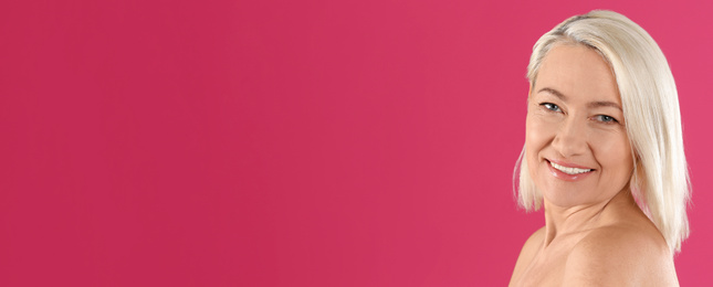 Image of Portrait of beautiful mature woman on pink background, space for text. Banner design