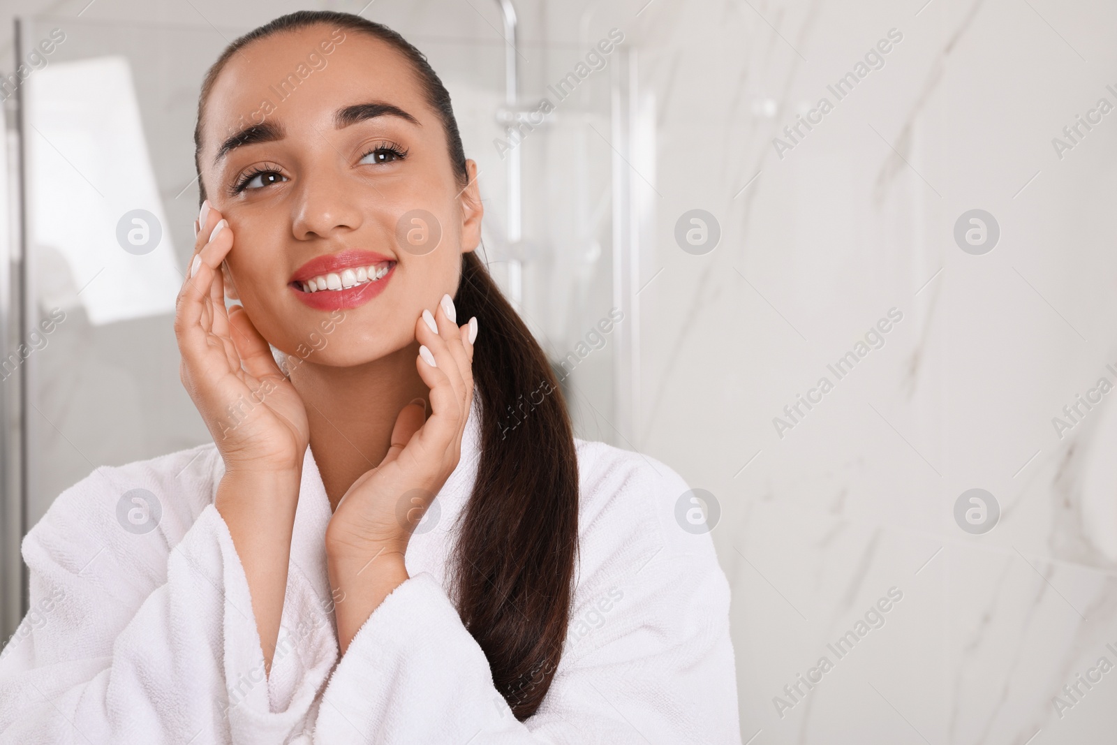 Photo of Beautiful young woman with perfect skin in bathroom, space for text. Facial wash