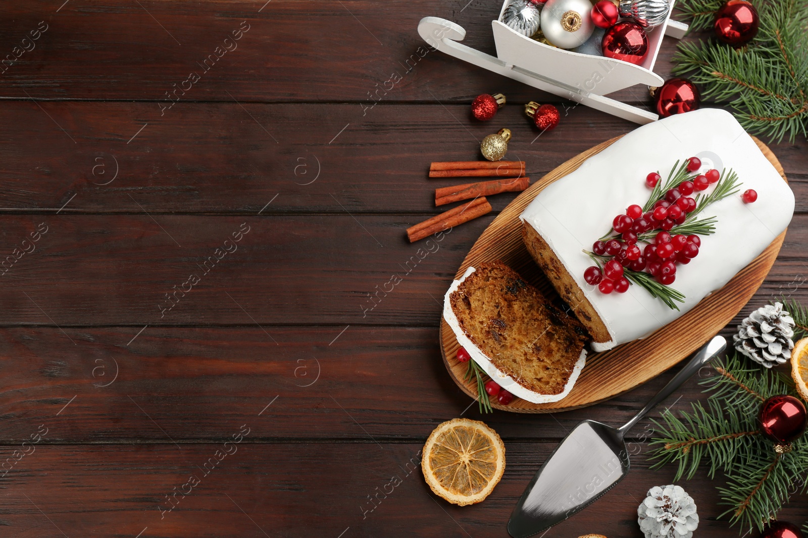 Photo of Flat lay composition with traditional classic Christmas cake on wooden table. Space for text
